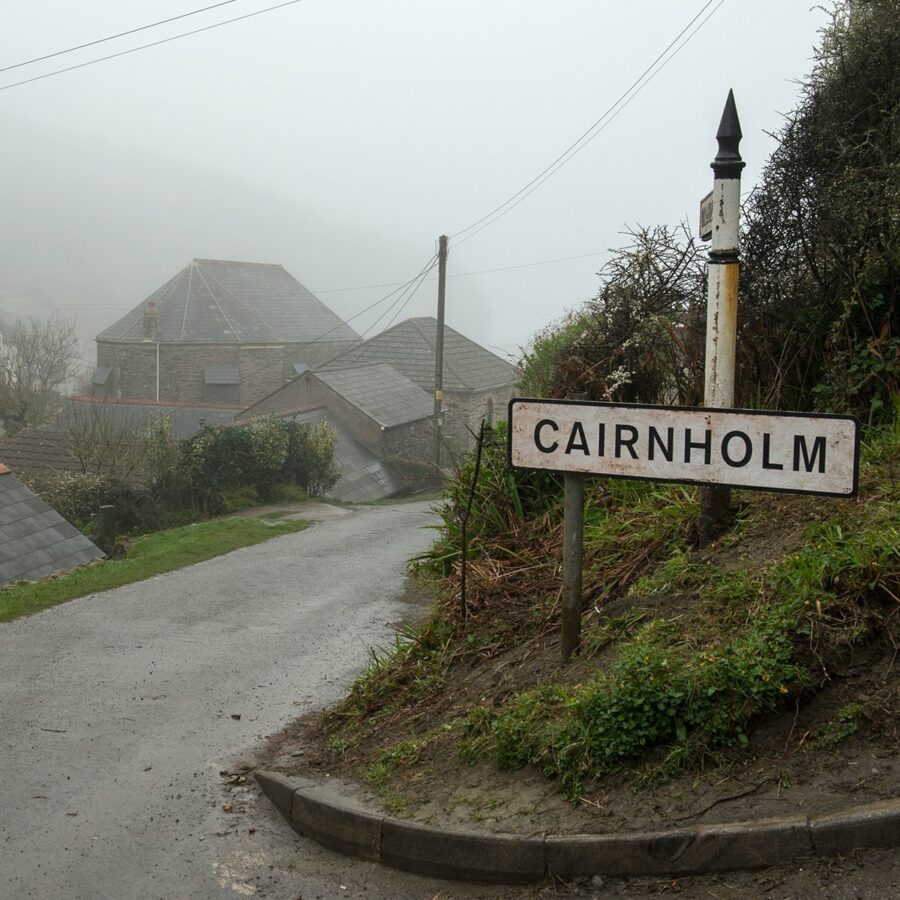 A picture of a road and sign that says CAIRNHOLM in Miss Peregrine's Home for Peculiar Children